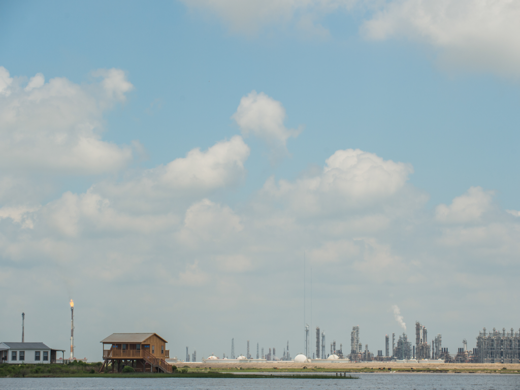 Homes in front of an oil refinery across the water